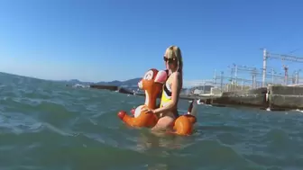 Alla is sexy riding a rare inflatable deer on the waves of the sea !!!