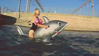 Alla has fun riding a big inflatable gray shark on the sea !!!