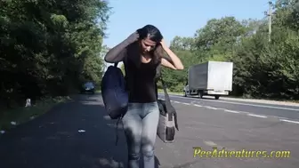 Skinny brunette hitchhiking with her bladder full
