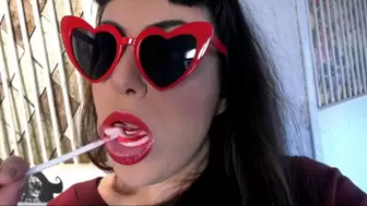 Lollipop sucking and heart-shaped glasses