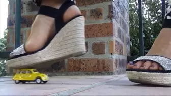 Natasha crushes a yellow toy car and plays with her shoes