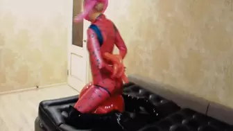 Alla is bound by balloons and she sits astride a balloon and wears a pink latex catsuit and boots!!!