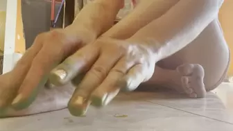 Green dyed fingers caress dirty feet and toes