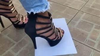 Brittany in dirty muddy 5 inch black strappy heels tapping on paper