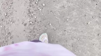 Flip flops and dirty feet walking down muddy road