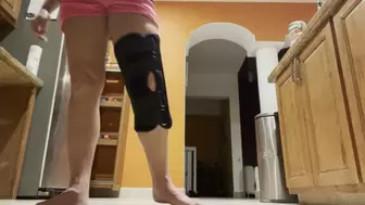Dirty feet and knee brace in the kitchen