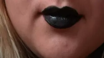 Black lipstick on lips and sharp teeth