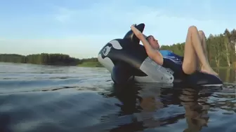 Alla has fun riding a black inflatable whale on the lake !!!