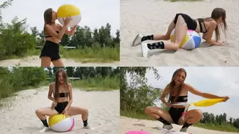 Natasha plays with a beach ball and sit to pop
