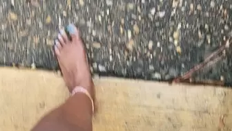 Ebony bare feet on the ground and grass