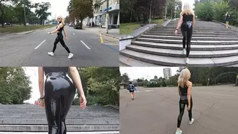 Katya walks in the park in latex leggings