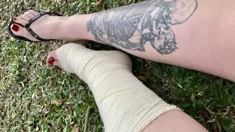 Hello Kitty walking in the park with her foot in a cast