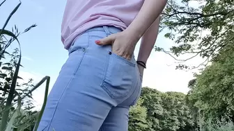 Blue jeans standing outdoor wetting peeing