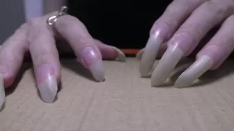 I scratching and damaging cardboard with sharp nails