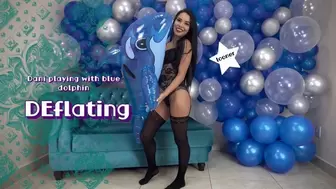 Dani plays and deflates inflatable dolphin