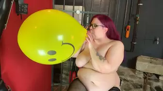 Blowing up and sit to pop a smiley balloon naked