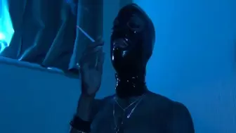 Topless Black Mistress smoking in latex mask