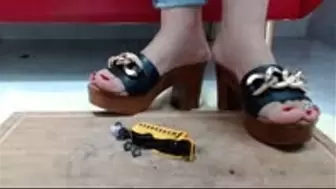 Crushing in wooden Sandals Heel a Schoolbus Metal Toycar