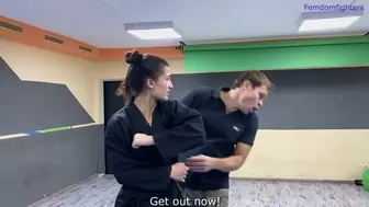 Karate girl kicks, footdominates and makes a lot of victory poses on gym security guy part1