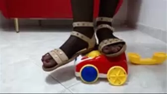 crushing a toy phone in 3 diffrent shoes (heels and sandals)
