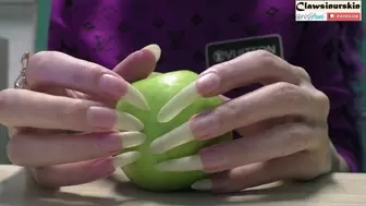aggressively clawing a green apple