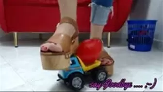 crushing a toy truck in wooden sandals