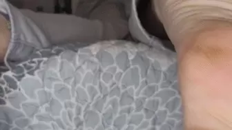 Dirty soles hanging off bed