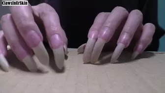 nails aggressively scratching cardboard
