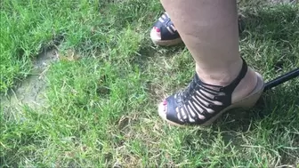 Debbie is Tapping Her Brown JBU Platform Wedge Heel Sandals in the Grass While Attending an Outdoor Concert