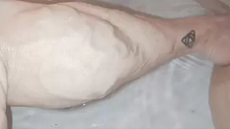 Veiny calves up close in tub