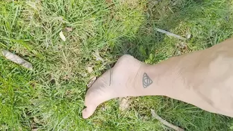 Tempest barefoot in grass and walking back to laundry