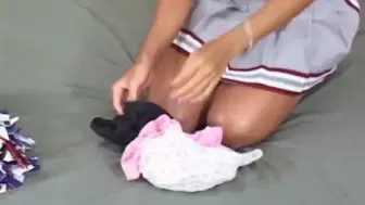Cheerleader stuffs panties in her pussy