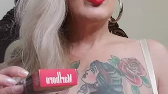 Blonde milf, red mouth, wearing a very sexy transparent bra, while inhaling and exhaling her red Marlboro
