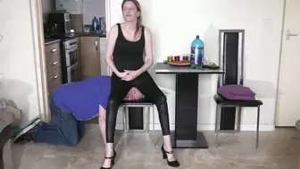Sitting On His Head On The Chair In Wet Look Leggings