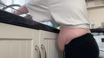 MastersLBS - pregnant housewife washing the dishes showing new bump