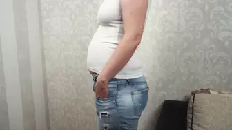 Bloated after dinner in tight jeans and shirt
