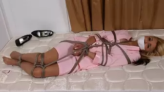 Petite blonde secretary Sandy Summers twists in a rope web applied by enemy Alexis Taylor, who also tape-gagged Sandy!