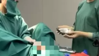 Patient getting a hand job by two doctors in the operating room