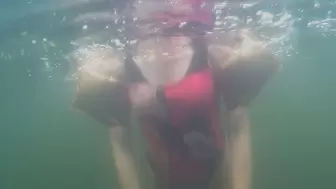Alla swims underwater in a diving mask and wears gold inflatable armbands for safety!!!