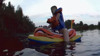 Alla is a hot rider on a large inflatable scooter on the lake in a rare inflatable vest Snorke Pro!!!