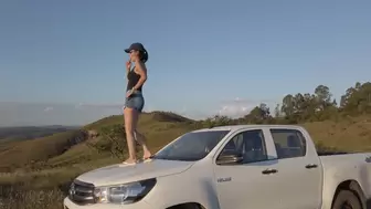 Bruna dances on the roof and hood of a Hilux and also revvs it hard