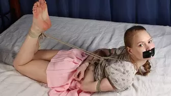 Irene: tapegagged barefoot girl, wearing t-shirt and skirt, hogtied with hemp rope, is moving and rolling on the bed, then camera man joins the party and starts tickling her (HD WMV)