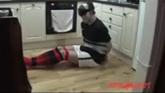 Tied up and taped footballer struggling in the kitchen