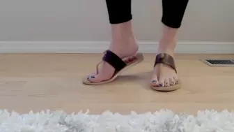 Arched feet show soles with brown sandals