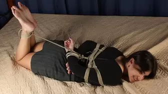 Lillian: hogtied barefoot girl, dressed in top and skirt, is wiggling and rolling on the bed, enjoying her first time in bondage (HD WMV)