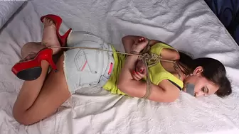 Tapegagged high-heeled Heidi in yellow tank top and cut-off jeans shorts, rope hogtied with her feet crossed, is trying to move somehow (HD MOV)