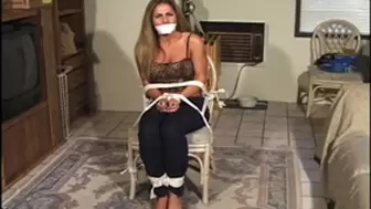 Pretty Sofia Samuels sits roped to a chair, her hands tied in front, bare feet toe-tied and a cloth tightened over her mouth!