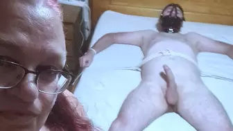 Handjob and cbt used on a naked man spreadeagled on bed