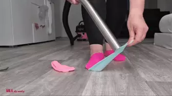 Mila vacuuming lego and socks