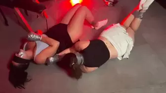 Two cheerleaders struggling in tape bondage